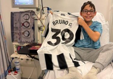 Charlie Denholm on dialysis unit with signed Bruno Guimaraes Newcastle United shirt