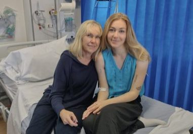 Mother and daughter sitting on a hospital bed together