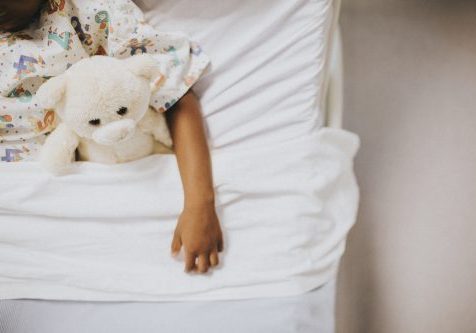 Little girl sleeping in a hospital bed