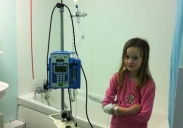 Poppy when she was a child with a drip
